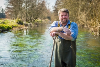 John standing in a river in his waders