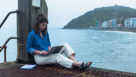 Freya using a laptop on harbour
