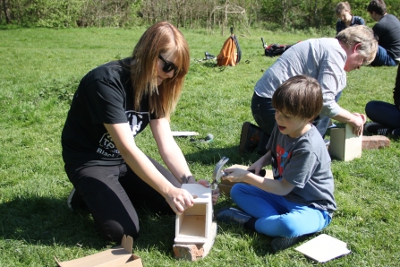 Engagment officer Emma helping child build a bird box