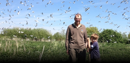 Nicholas Watts on the farm with his grandson